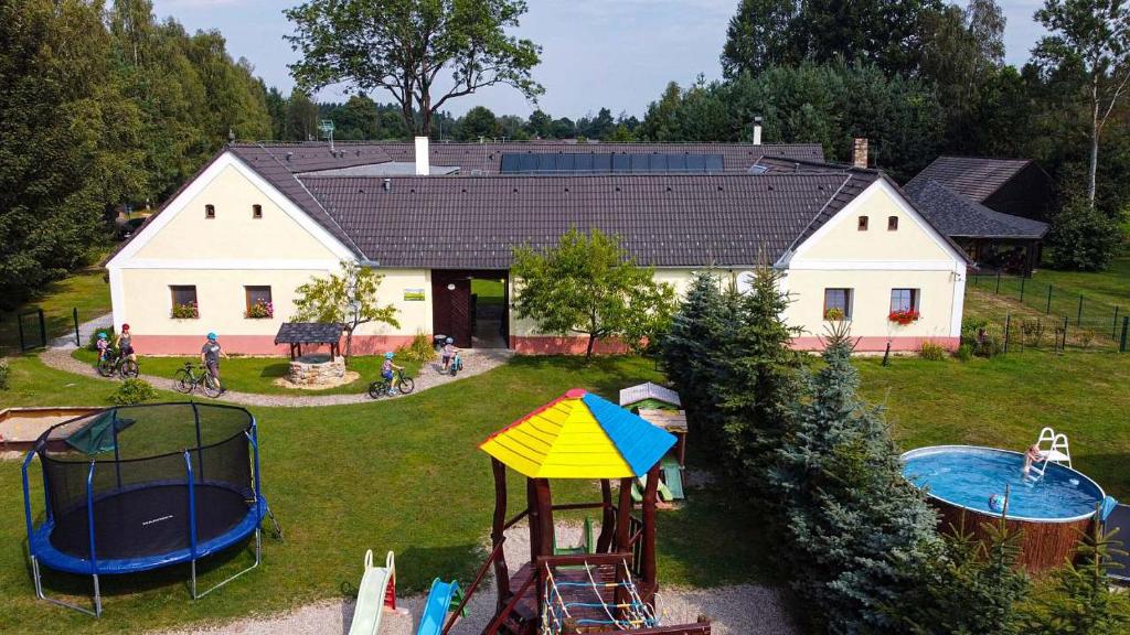 an aerial view of a house with a playground at Rodinný penzion Bavlnka in Německé