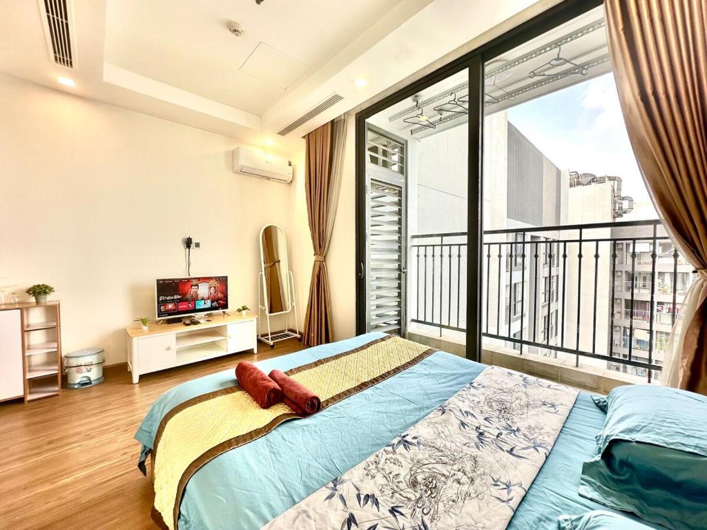 a bedroom with a bed and a large window at Deluxe Studio Apt Next Nation Convention Centre and Keangnam in Hanoi