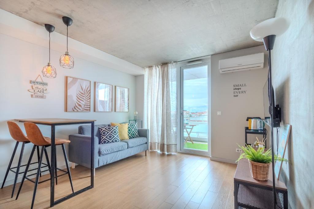 a living room with a table and a couch at Cozy Luxury Apartment in Aveiro in Aveiro