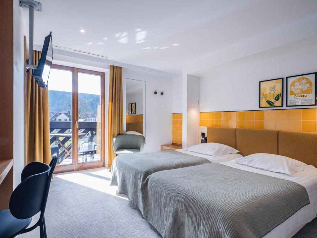 Postel nebo postele na pokoji v ubytování Hotel Au Vieux Moulin