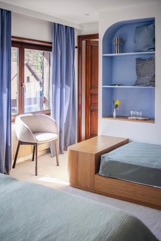 Postel nebo postele na pokoji v ubytování Hotel Au Vieux Moulin