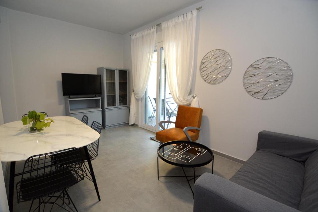 a living room with a couch and a table at IRON House in Kavála
