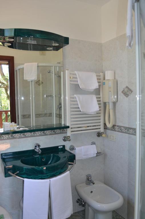 a bathroom with a green sink and a toilet at Hotel Villa Cipro in Venice-Lido