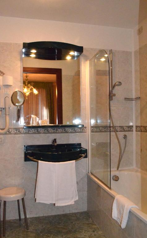a bathroom with a shower and a sink and a tub at Hotel Villa Cipro in Venice-Lido