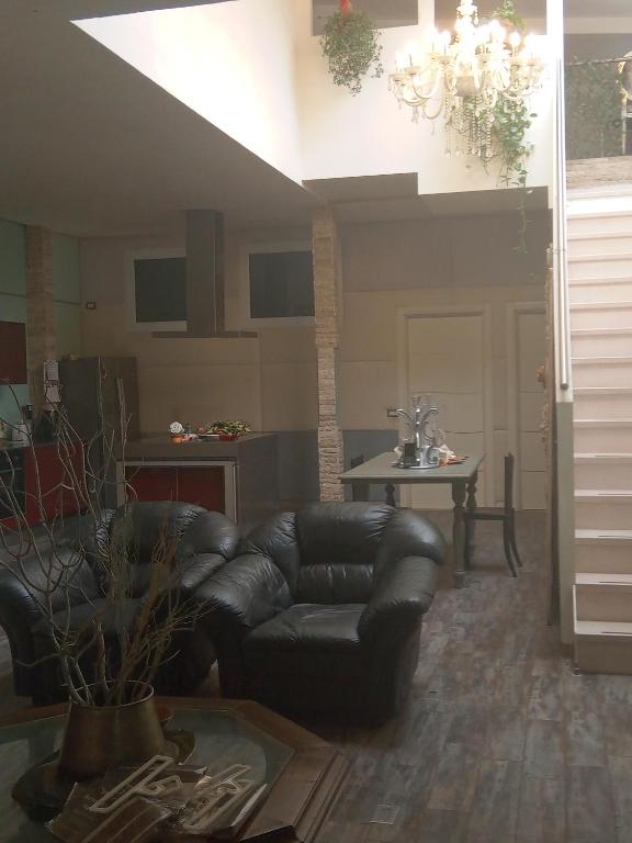 a living room with a leather couch and a table at buon Talenti House in Florence