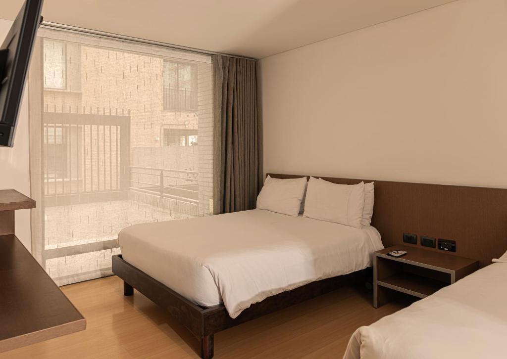 Postel nebo postele na pokoji v ubytování Hotel Viaggio Nueve Tres