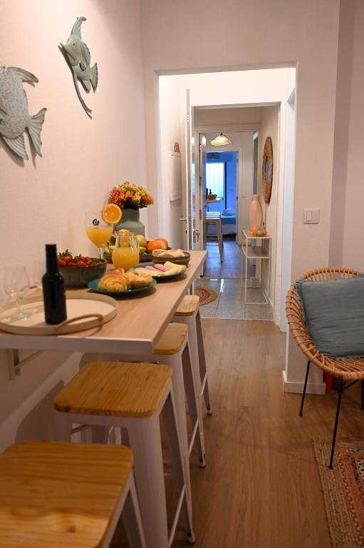 a dining room with a table with fruits on it at Downtown Lovely in Vila Real