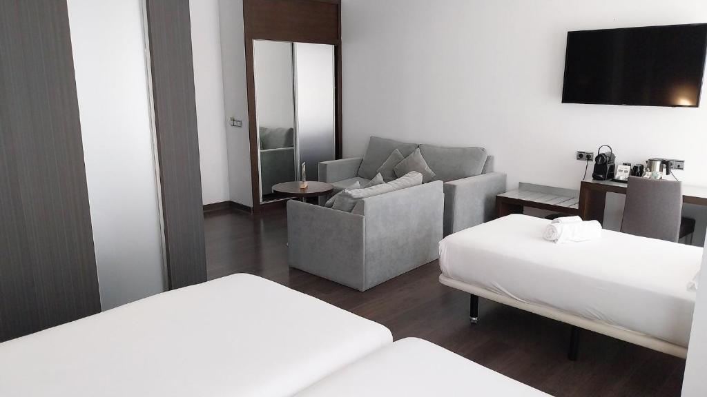 Postel nebo postele na pokoji v ubytování Sercotel Coliseo