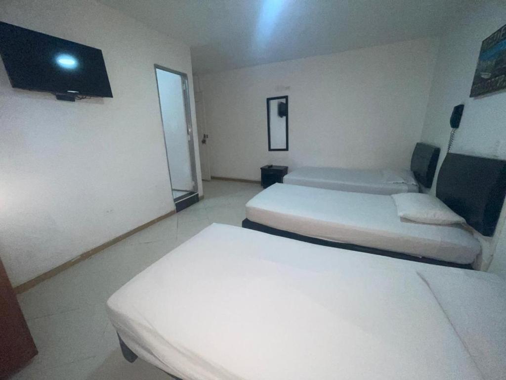 Postel nebo postele na pokoji v ubytování Hotel Villa Real