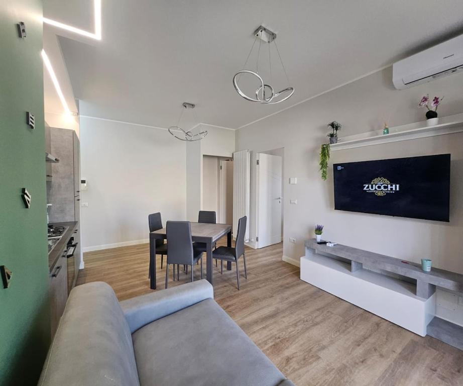 a living room with a couch and a table with chairs at Green Suite Apartment in Santa Maria delle Mole