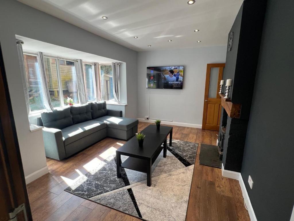 a living room with a couch and a table at Luxury Detached holiday home Near BHX, JLR, NEC in Birmingham