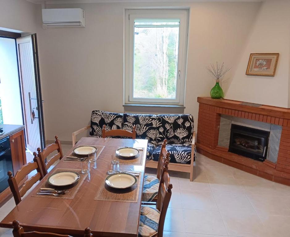 a dining room with a table and a fireplace at La Casa del Mugnaio in Rotonda