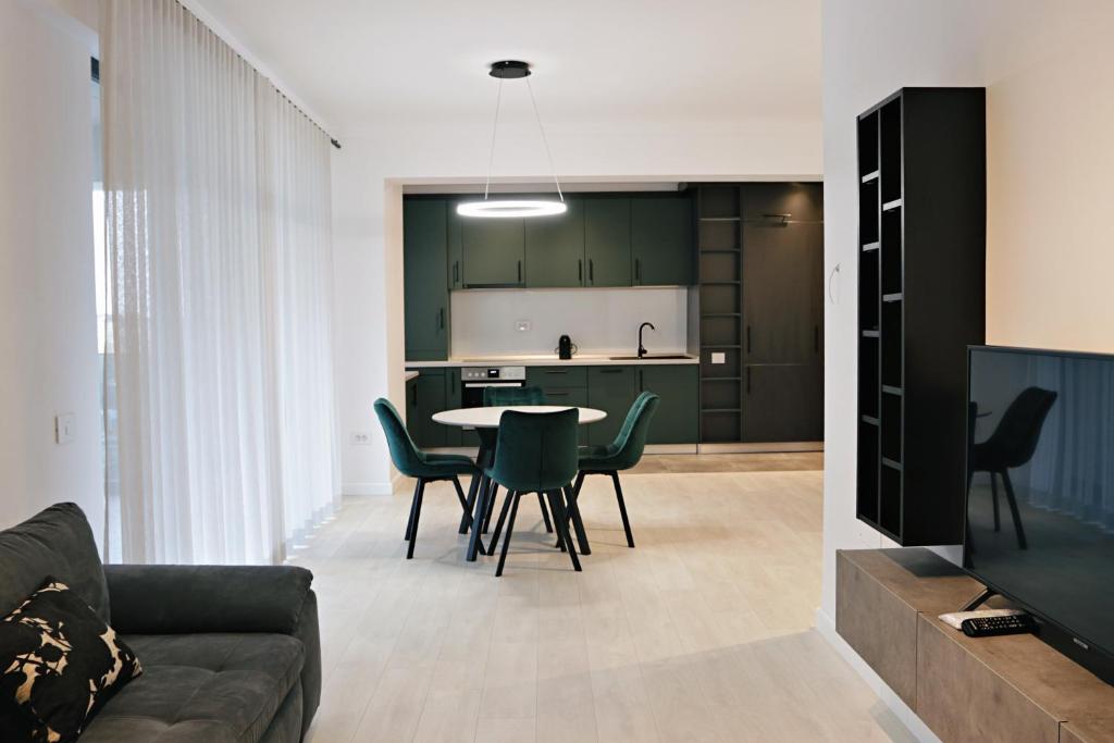 a living room and kitchen with a table and chairs at Via Vida I 2 Bedroom Apartments on Pipera Blvd in Voluntari