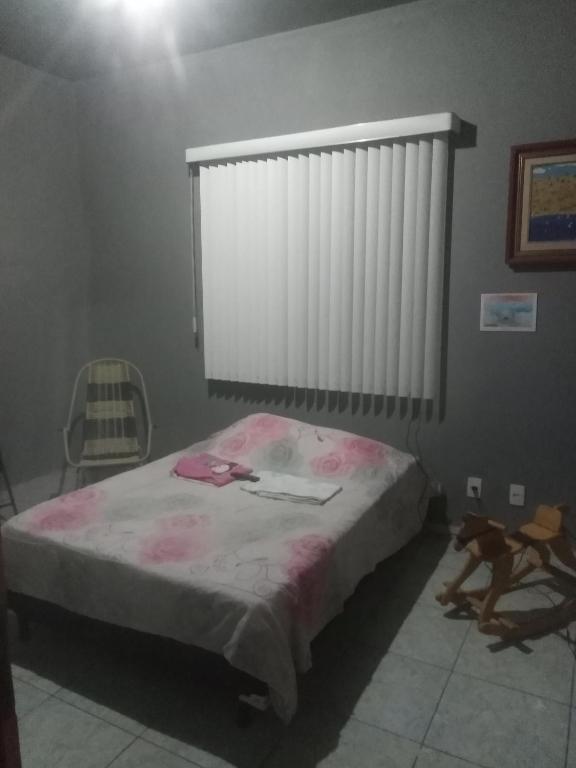 Postel nebo postele na pokoji v ubytování Quarto de Hóspedes da Menina Maricotinha