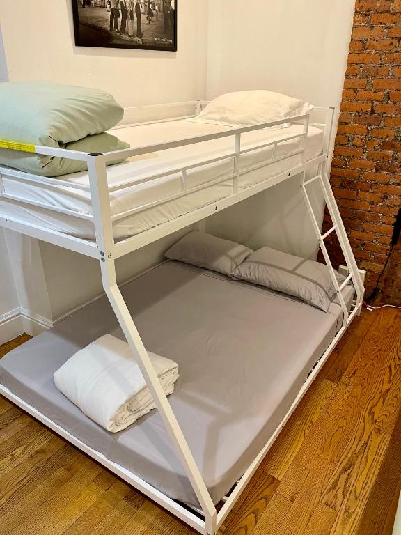 a white bunk bed with pillows and towels at Nestel Nest 1 bedroom apartment in New York