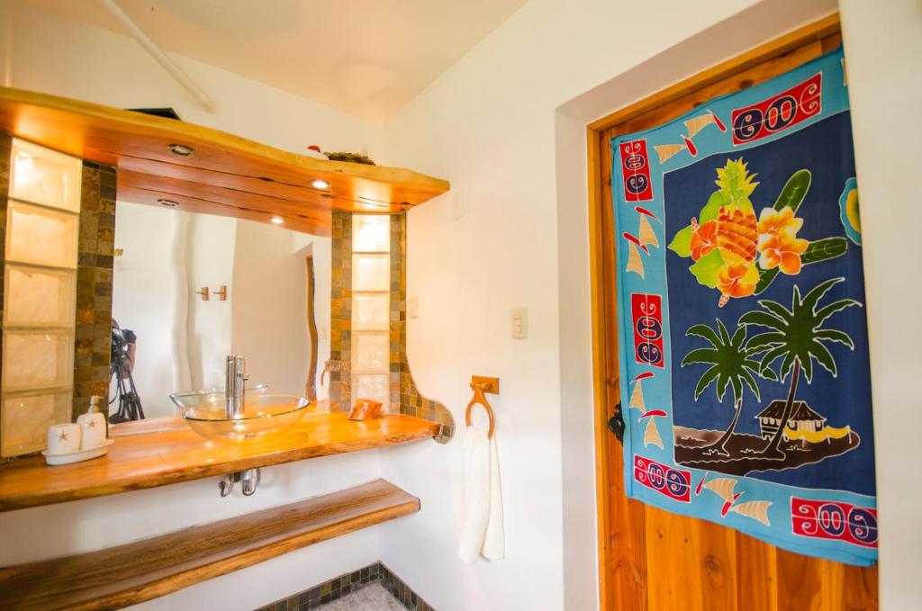 a bathroom with a sink and a mirror at Cabañas Moai in Hanga Roa
