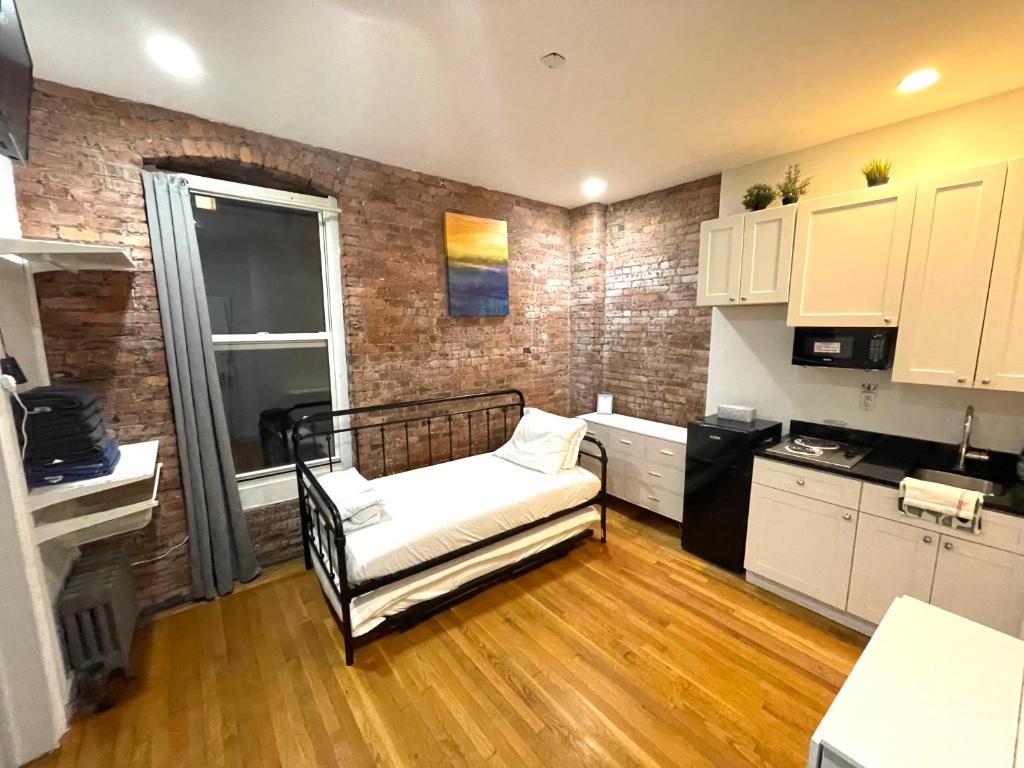 a room with a kitchen with a chair in it at Nestel Nest 1 bedroom apartment in New York