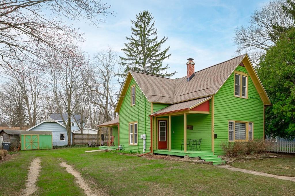 a green house with a brown roof at The Green Street Getaway in South Haven
