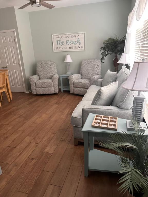 ein Wohnzimmer mit einer Couch und einem Tisch in der Unterkunft Beautiful Two Bedroom, Two Bathroom First Floor Condo in Gulf Shores! in Gulf Shores