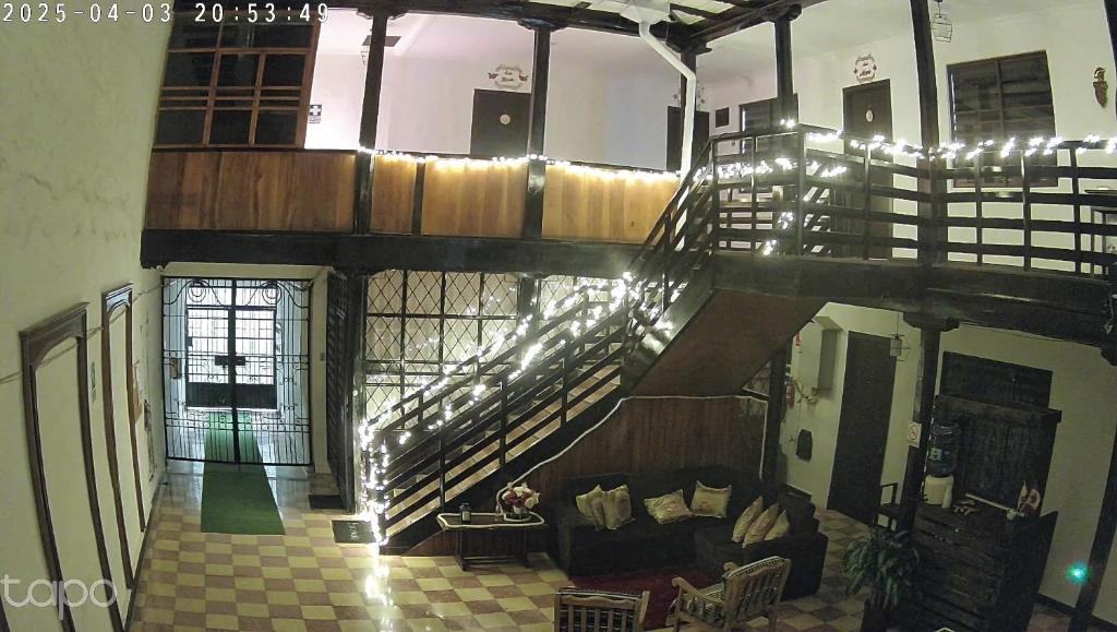 a living room with a staircase and a couch at Suite La Pergola - El Renacimiento Suites in Cuenca