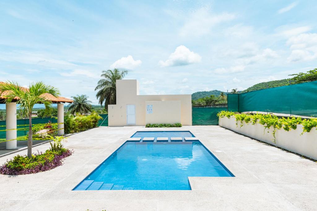 a pool in the backyard of a house at Departamento amplio con alberca y asador - Hasta 14 personas - B3 in Puerto Vallarta