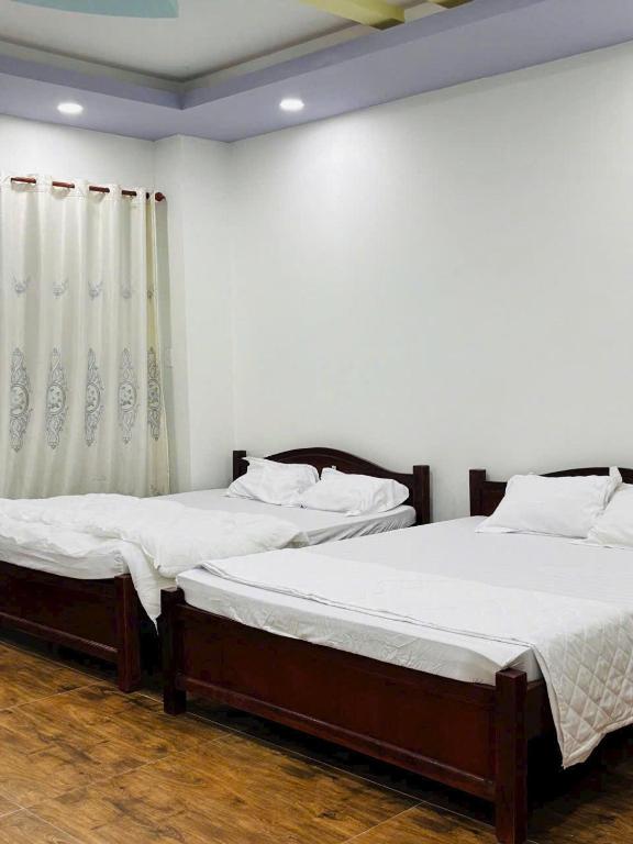 Postel nebo postele na pokoji v ubytování HOTEL MOTeL Đồng Khởi
