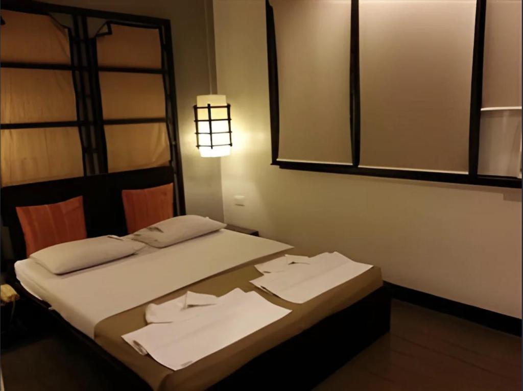 Postel nebo postele na pokoji v ubytování Hotel Mikka