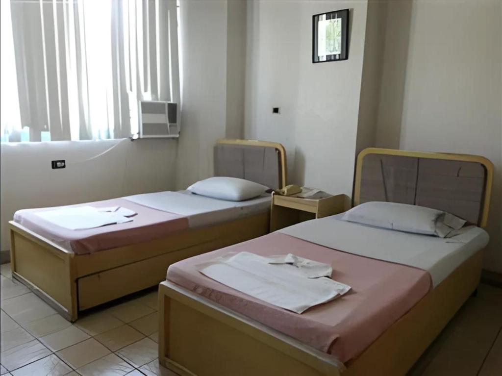 Postel nebo postele na pokoji v ubytování Hotel Mikka