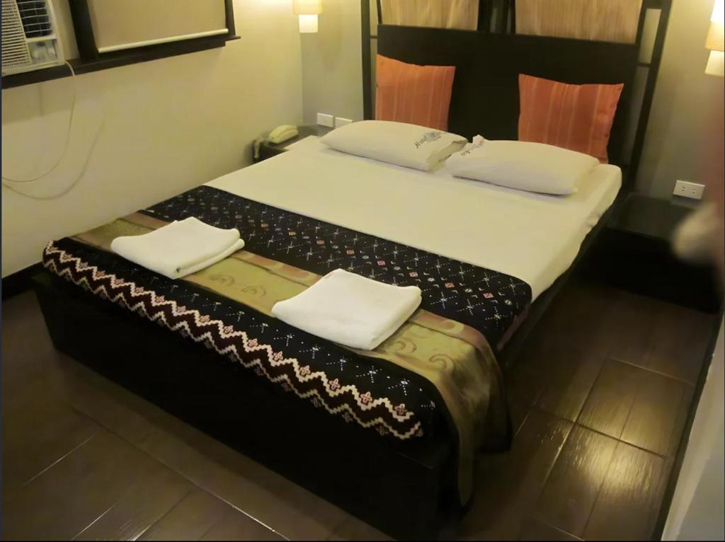 Postel nebo postele na pokoji v ubytování Hotel Mikka