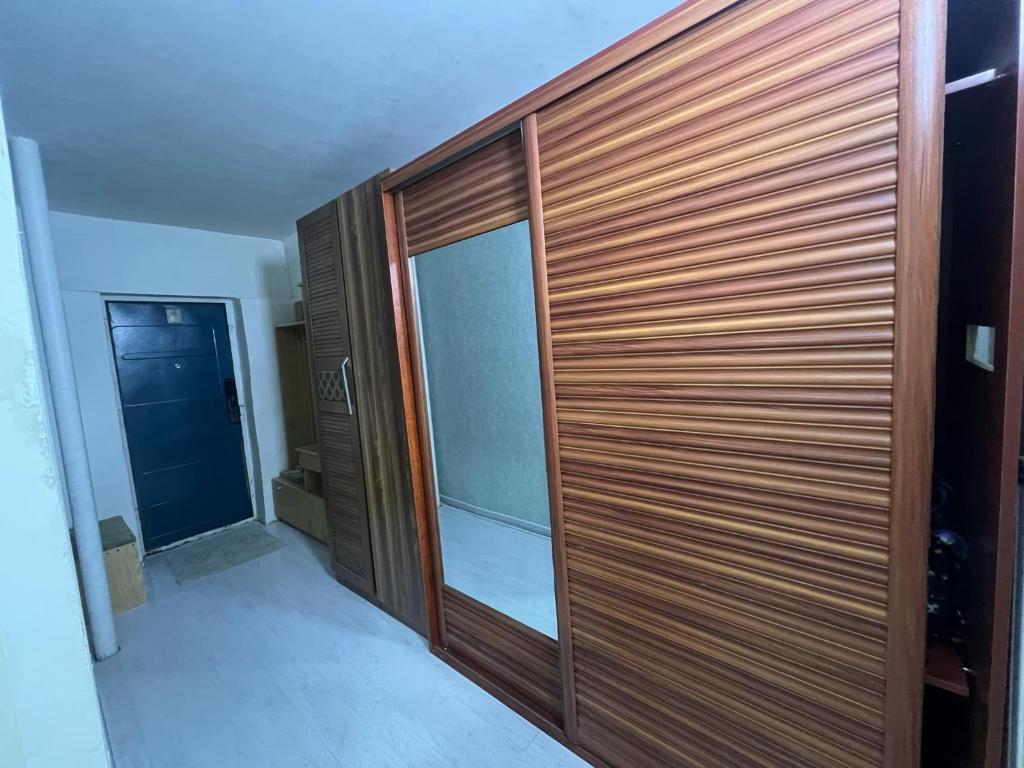 a wooden pivot door in a house at Zebra Guest House in Ulaanbaatar