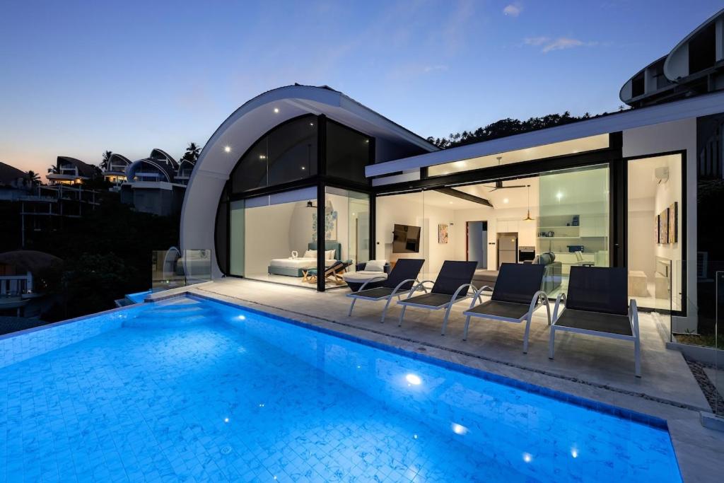 a swimming pool in front of a house at Chaweng Noi Horizon Villa in Amphoe Koh Samui