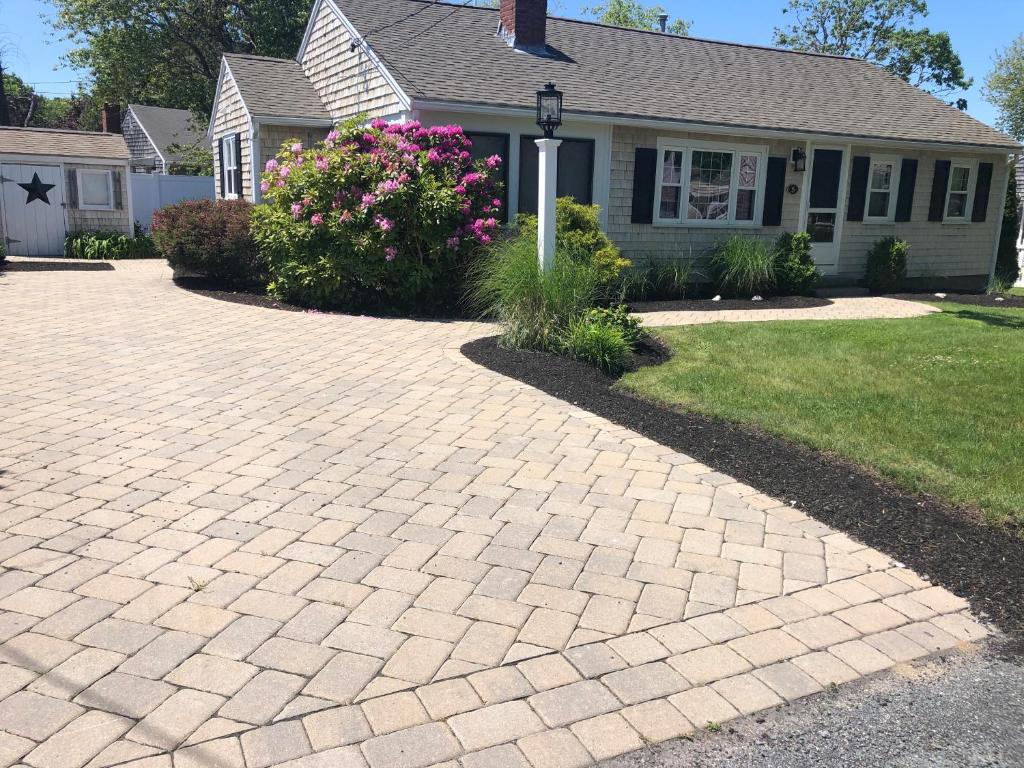 a brick driveway in front of a house at ONE Minute walk to BEACH! High end home special! in Dennis Port