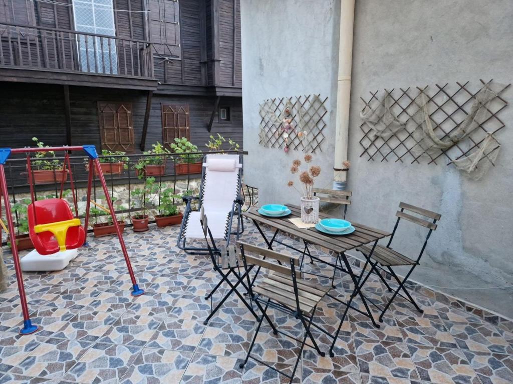 a table and chairs sitting on a patio at Apartament Magi in Sozopol