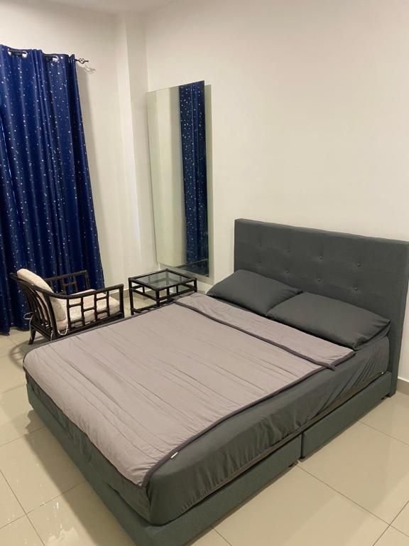 a large bed in a room with a mirror at A Home - Homestay near St Anne Church Bukit Mertajam in Bukit Mertajam