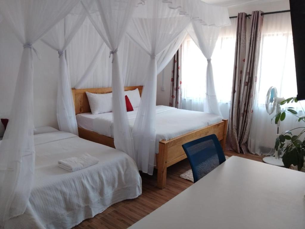 Postel nebo postele na pokoji v ubytování Annodas Homes Milimani Kisumu