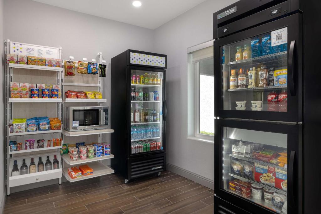 a refrigerator with its door open in a kitchen at Spark By Hilton Santa Nella in Santa Nella