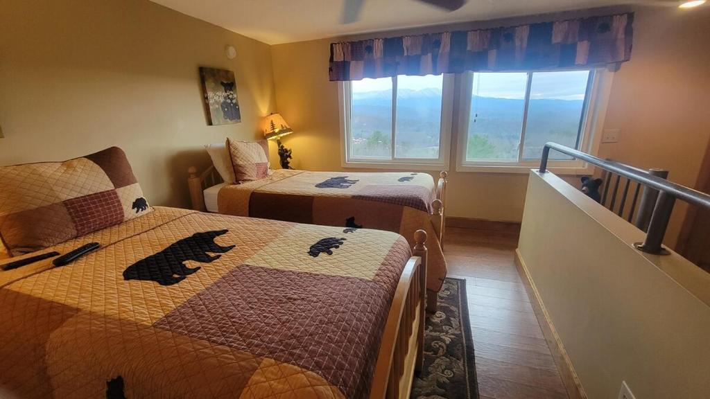 a hotel room with two beds and a window at Mountain View Retreats in Gatlinburg
