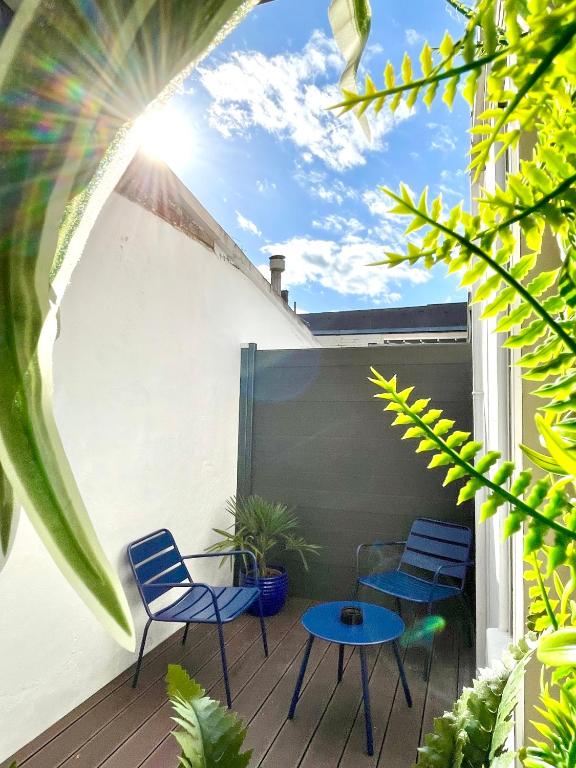 patio z krzesłami i stołami na balkonie w obiekcie Escale bohème - Terrasse en centre-ville - Gare w Amiens