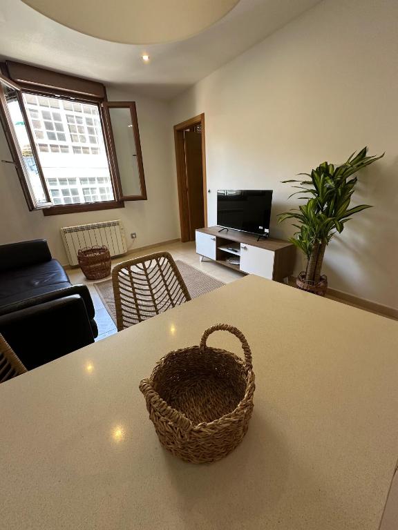 a living room with a table with a basket on it at Estudio centro in Pontevedra