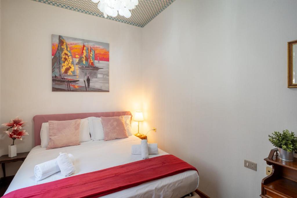 a bedroom with a bed and a painting on the wall at Pool and Relax at Casa Ilenia in Bordighera