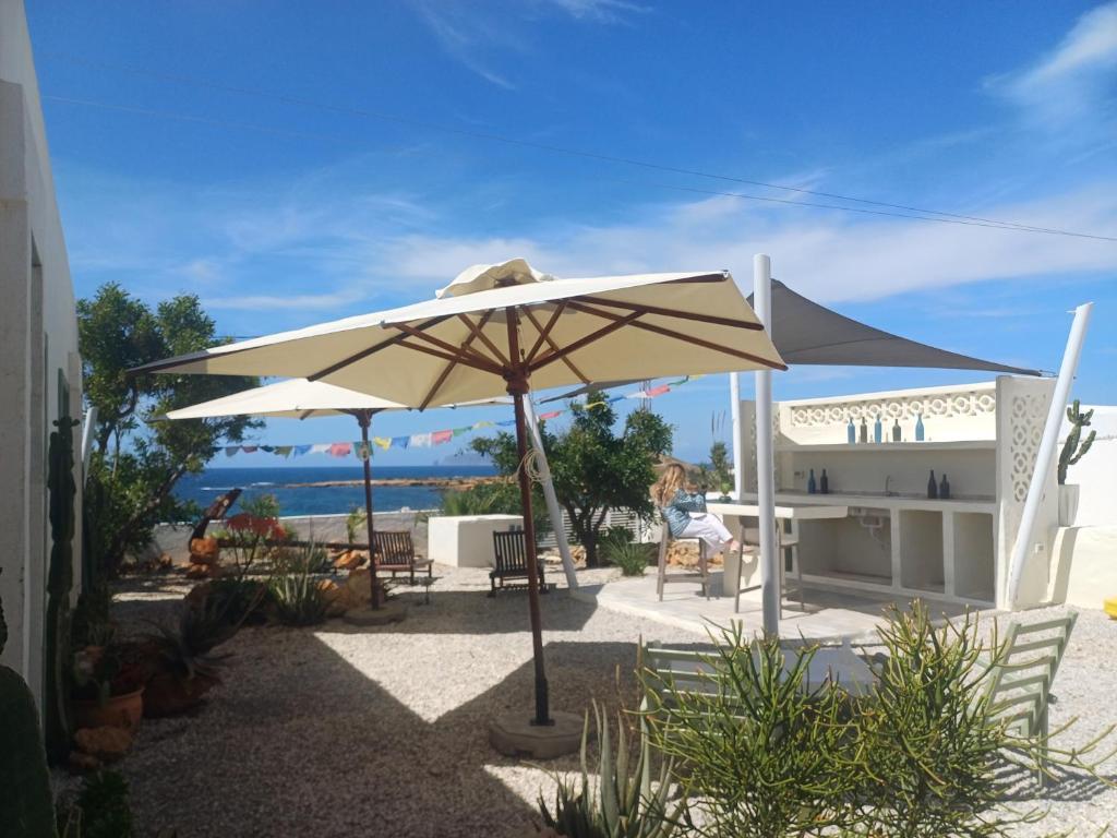 a patio with an umbrella in front of a house at CasaEole in El Haouaria