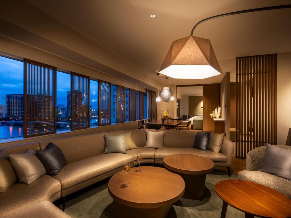 a living room with a couch and a table at Niigata Grand Hotel in Niigata