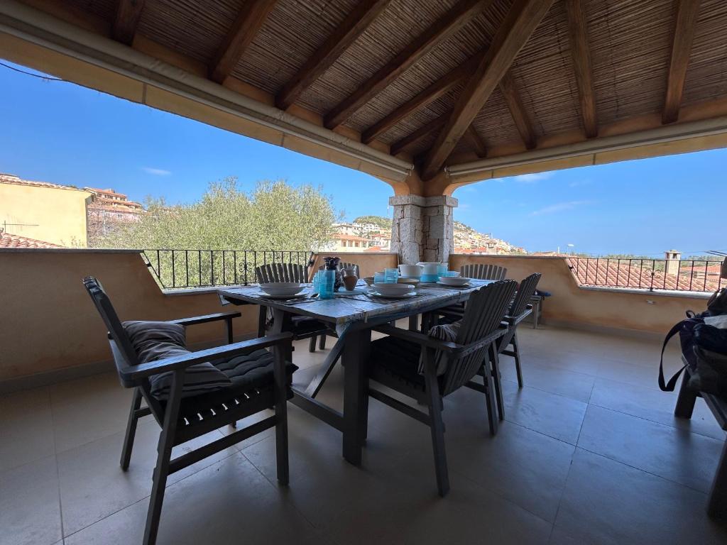 a dining table and chairs on a balcony with a view at Casa Giumagio by Holiday World in Posada