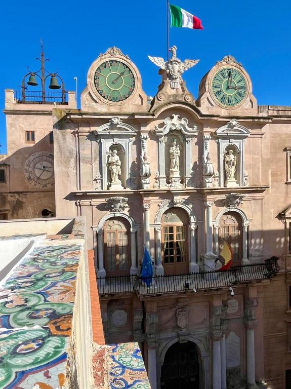 a building with a clock on top of it at Casa Garibaldi in Trapani