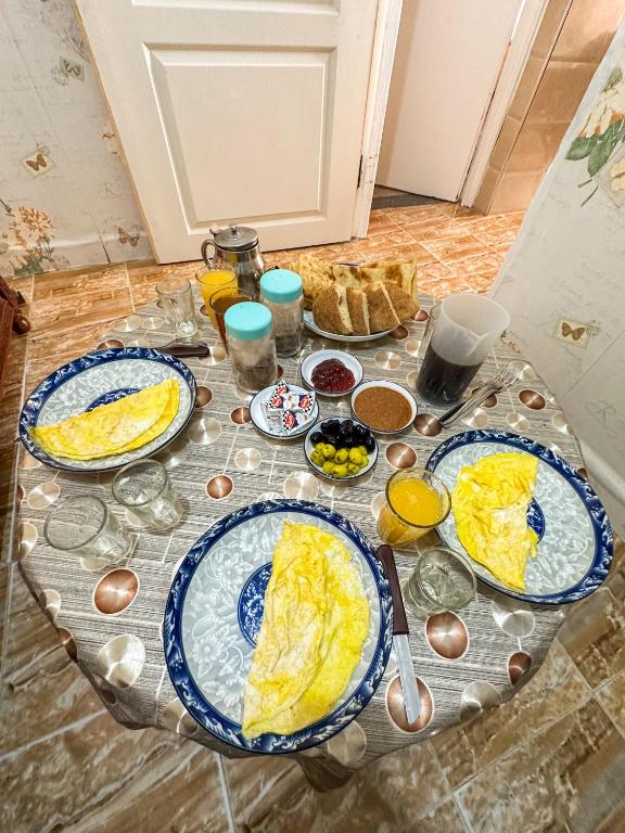 a table with three plates of eggs on it at Surf and Stay Anza - Surf Territory in Agadir