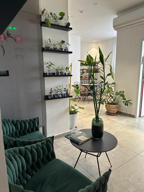 a room with a couch and a table with plants at Sun Sea Center in Eilat