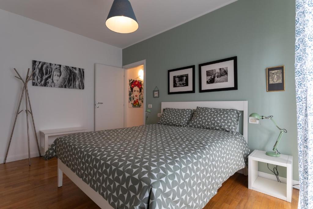 a bedroom with a bed with a gray comforter at Il Piccolo Giardino in Crespellano