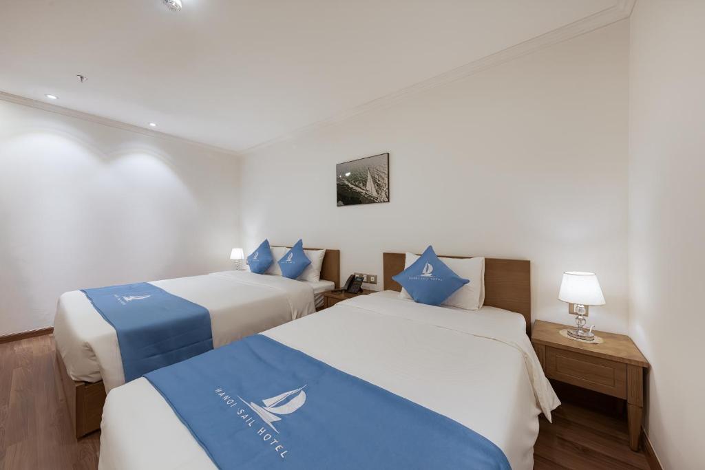Postel nebo postele na pokoji v ubytování Hanoi Sail Hotel