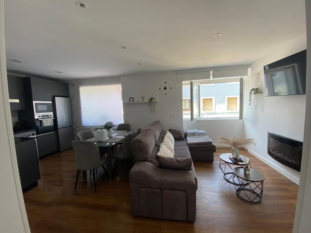 a living room with a couch and a table at Apartamento El Baluarte in Cudillero