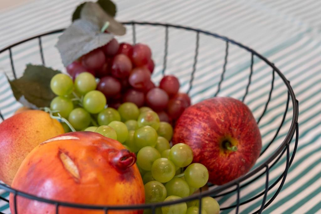 a basket of fruit sitting on a table at Martini Matera 2-luxury apartment in Matera